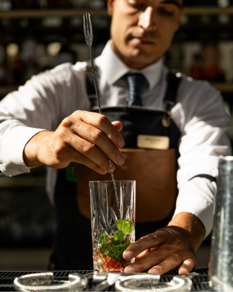 Bartender preparing a cocktail at Grecotel LUXME White Crete.