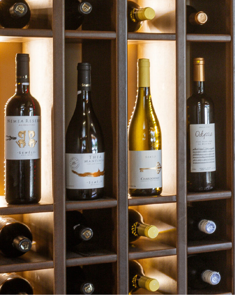 Wine bottles displayed in the Wine Library at Grecotel LUXME White Crete.