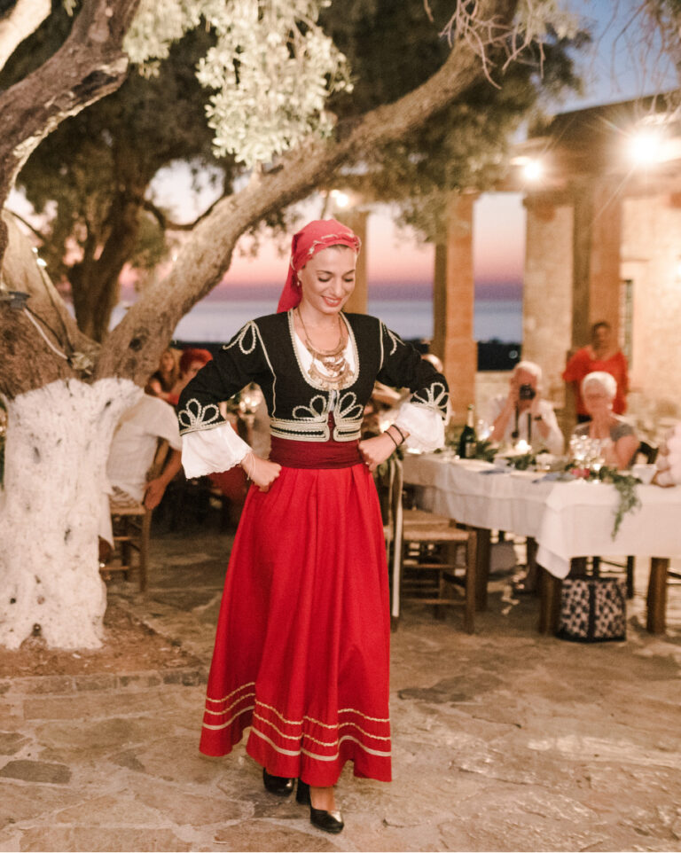 Traditional Cretan celebration at Grecotel Agreco Farm with a dancer in traditional dress.