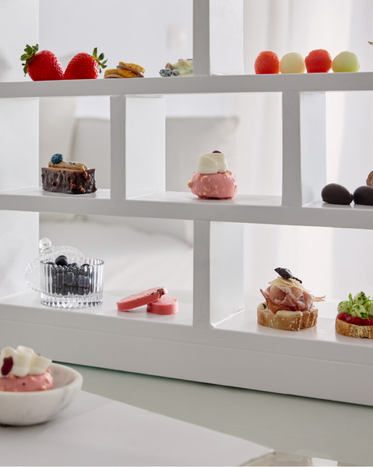 Afternoon tea selection with fruit, pastries and savoury bites at Grecotel LUXME White Crete.