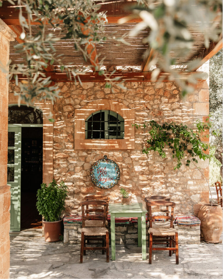 Stone dining area at Grecotel Agreco Farm with traditional Cretan decor.
