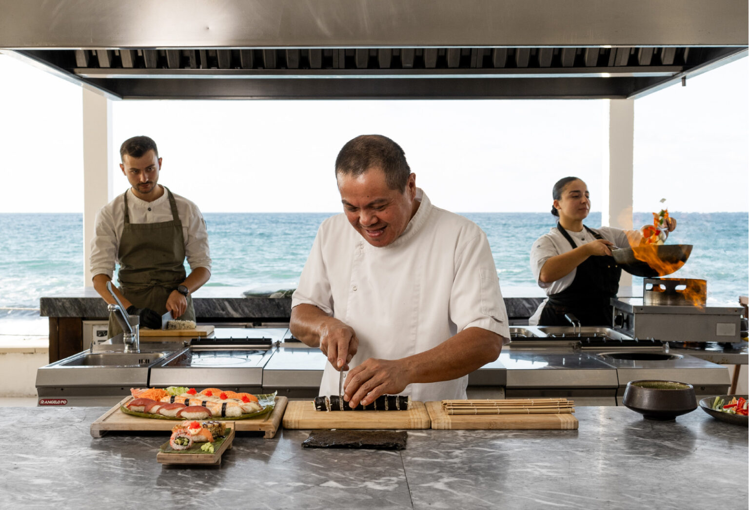 Chefs preparing sushi at Asia White Restaurant overlooking the sea at Grecotel LUXME White Crete.