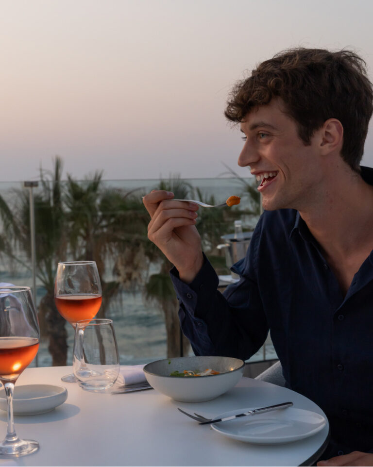 Guest dining at Lobsteria with a sea view at Grecotel LUXME White Crete.