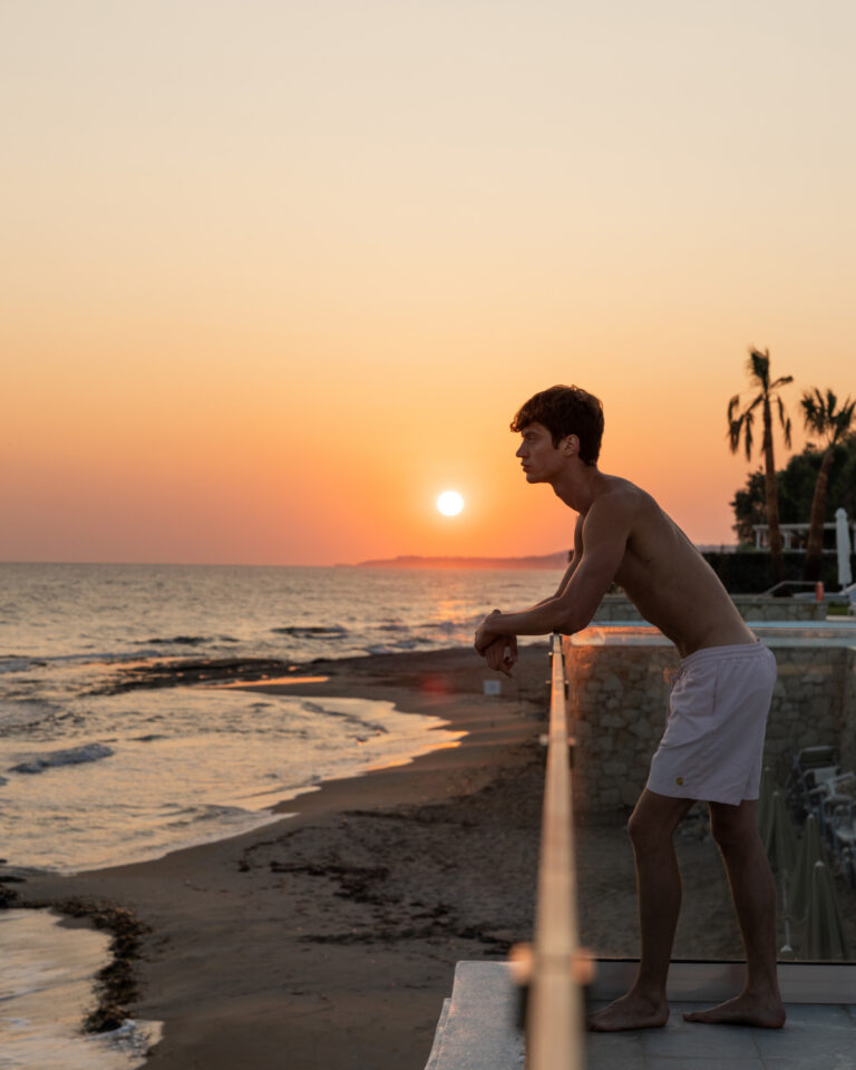 Man overlooking the sea at sunset at Grecotel LUXME White Crete.
