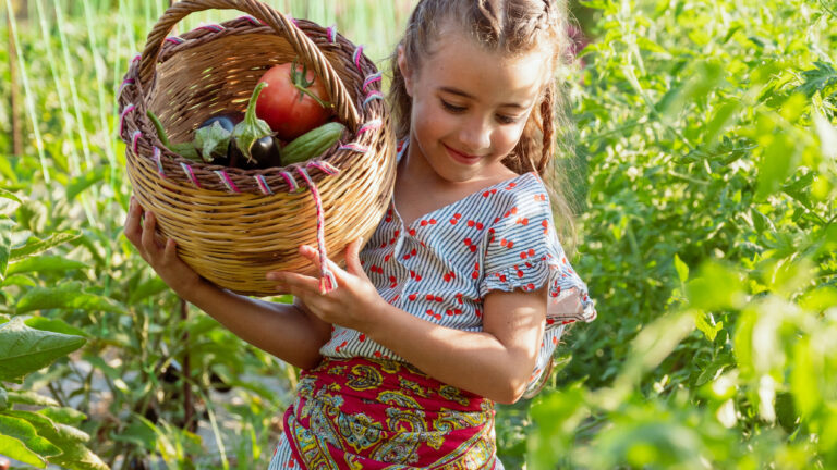 Child taking part in a farmer-for-a-day experience at Grecotel Agreco Farm in Crete.