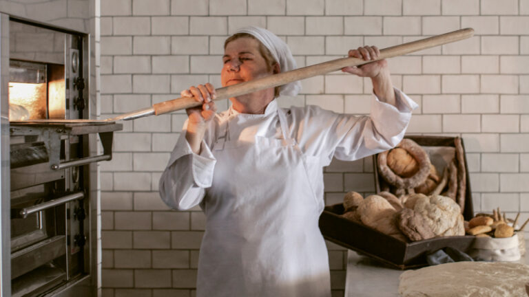 Baker preparing bread at The White Bakery at Grecotel LUXME White Crete.