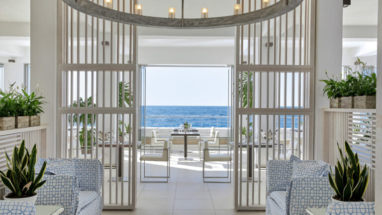 Grecotel LUXME White Crete Ventanas il Mar restaurant with sea view and outdoor seating.