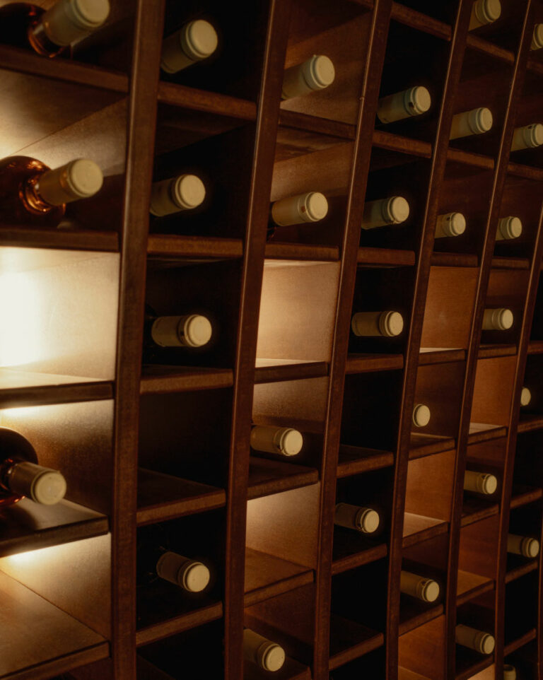 Wine bottles displayed in the Wine Library at Grecotel LUXME White Crete.