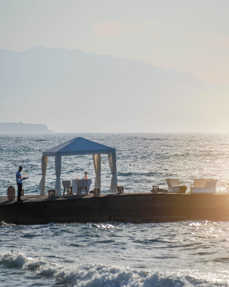 Private dining setup in a seaside cabana at Grecotel LUXME White Crete.
