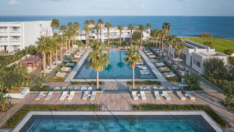 Grecotel LUXME White Crete resort buildings, pools and sea view.
