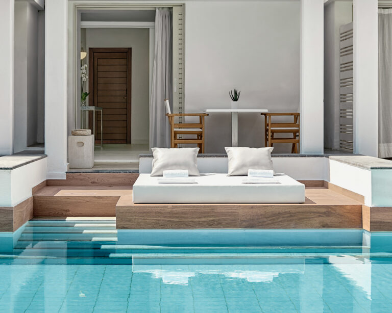 Grecotel LUXME White accommodation with pool, daybed and outdoor seating.