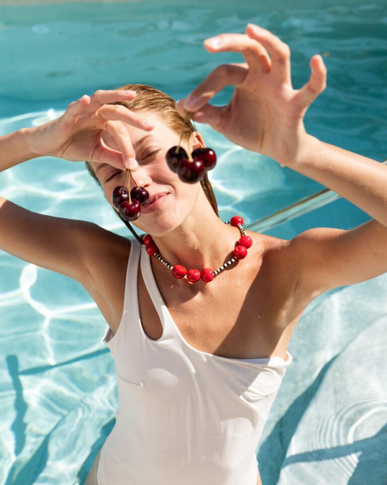 Woman relaxing in the pool at Grecotel LUXME White.